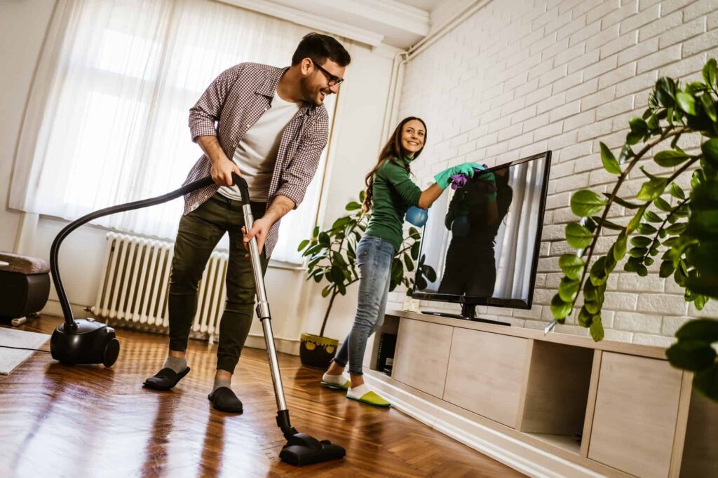 Efficient couple cleaning their home together, portraying the teamwork and dedication that defines our professional cleaning services.