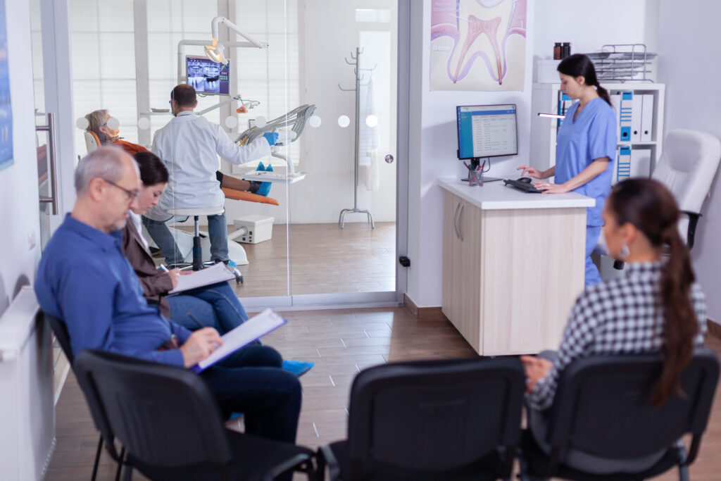 Busy stomatology waiting area as people fill out forms to hire Leading Commercial Cleaning, the top commercial cleaning service for property owners. Find us at 515 Kent Street, North Sydney, NSW, Australia, New South Wales. Elevate cleanliness and professionalism with our specialized services.